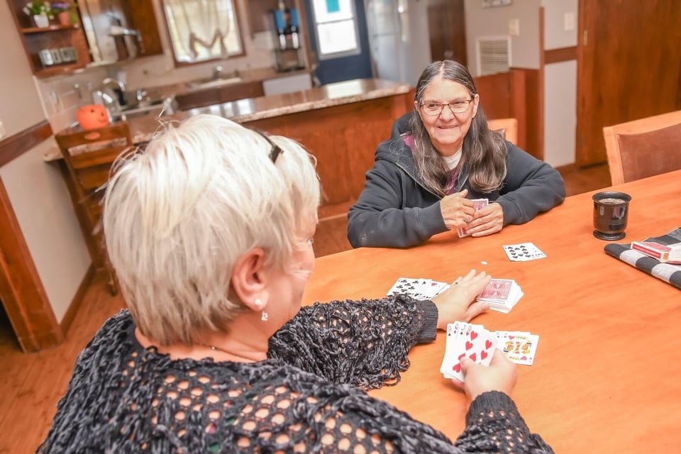 women playing cards at kitchen table