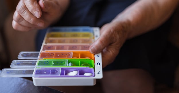 Senior using pill organizer