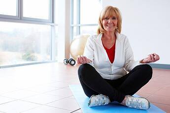 older woman in yoga pose