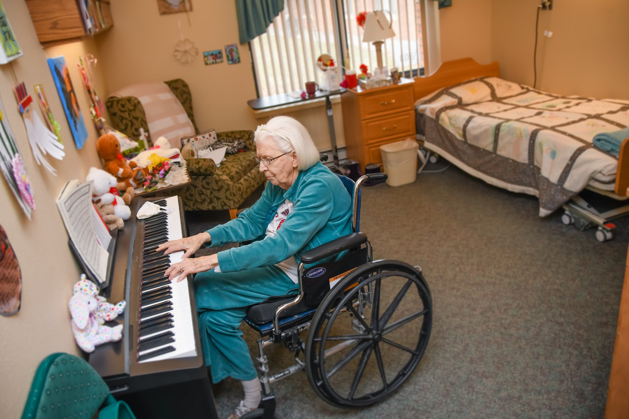 woman in wheelchair playing piano