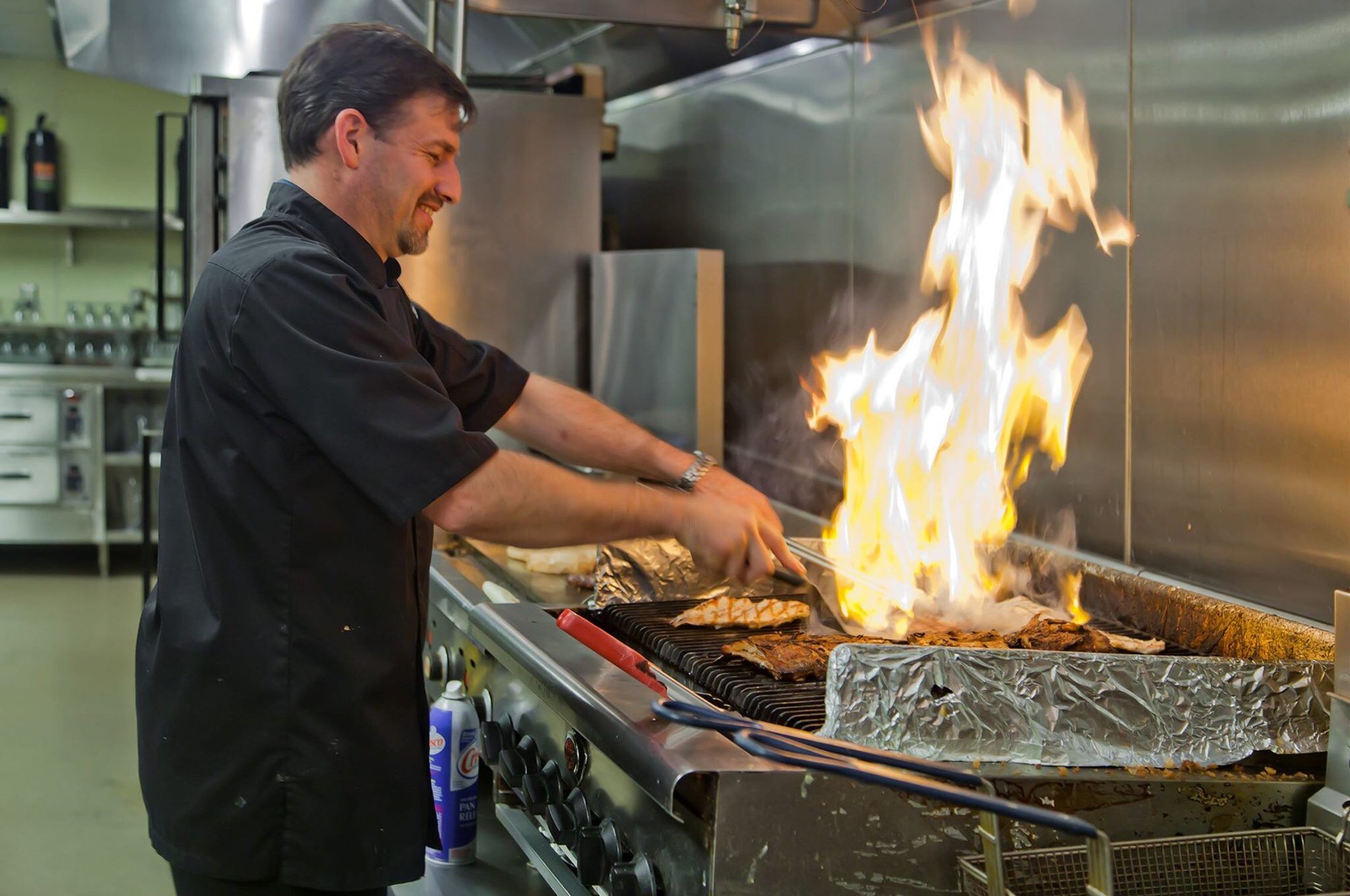 Photo of a chef grilling at the Pioneer Grill by Vivie