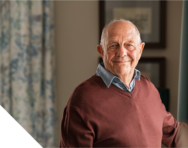 Photo of an older man in sweater smiling