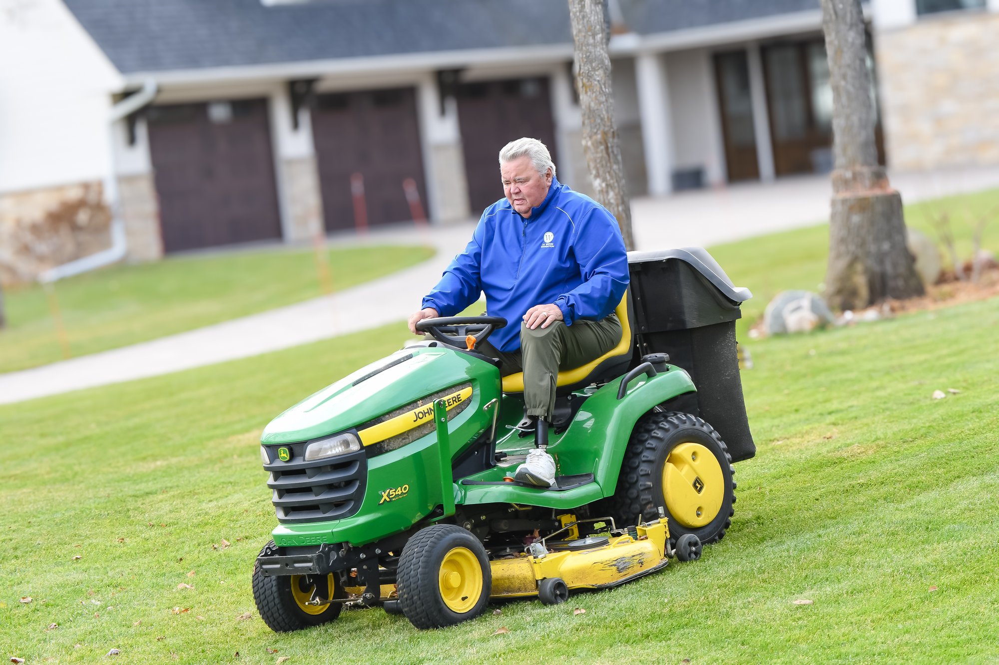 man on riding lawnmower