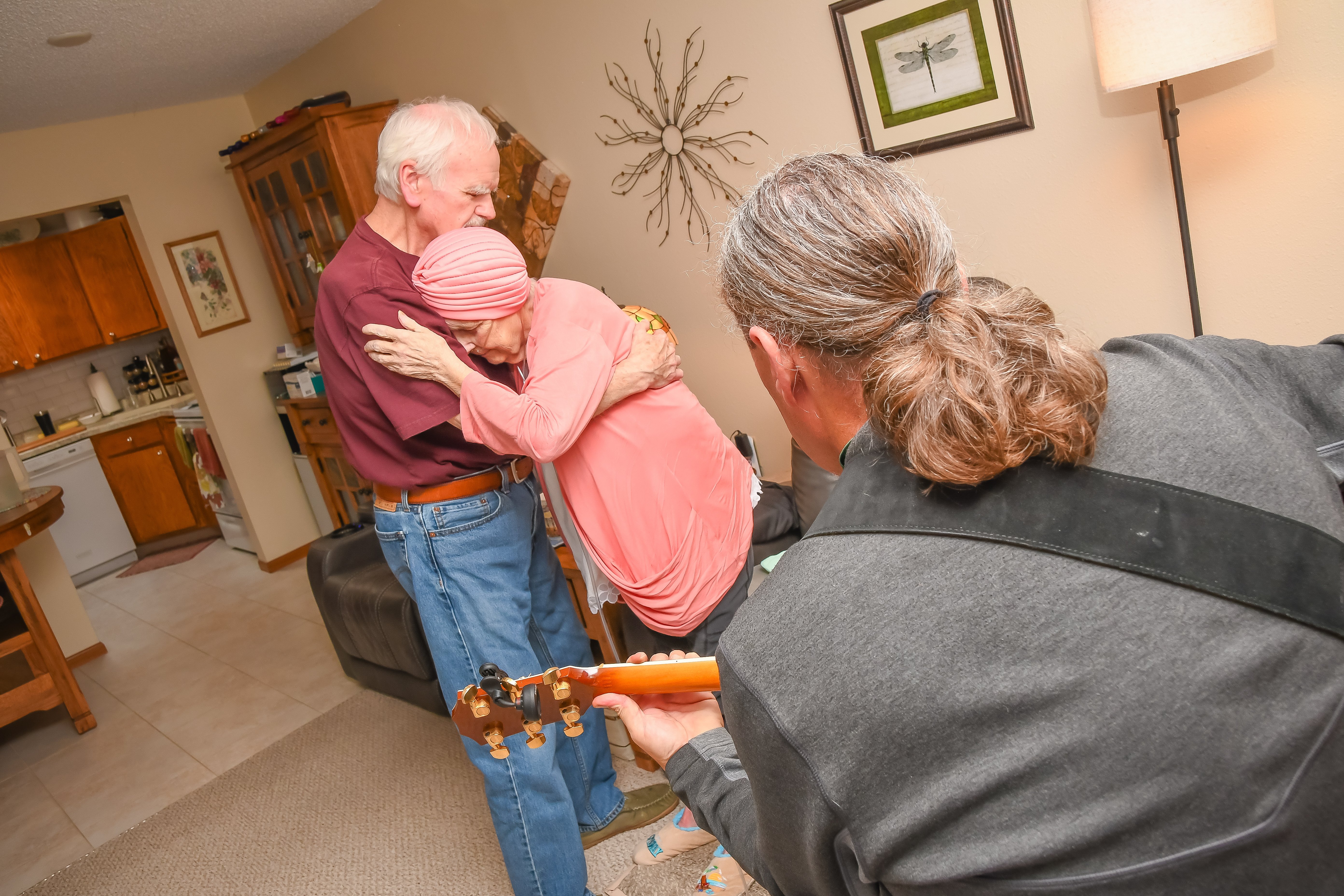 two people dancing to musician with guitar
