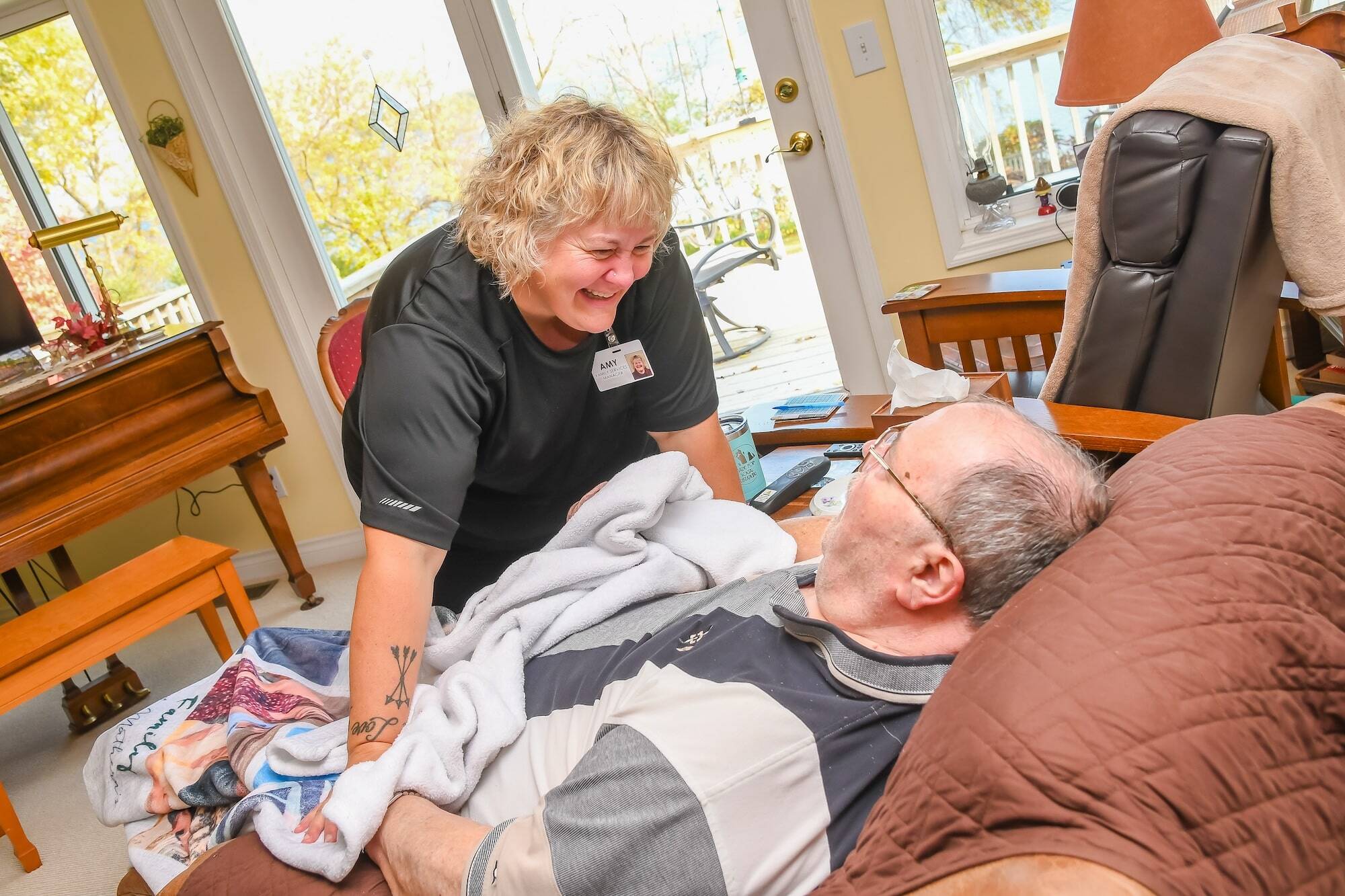 woman smiling at man in bed