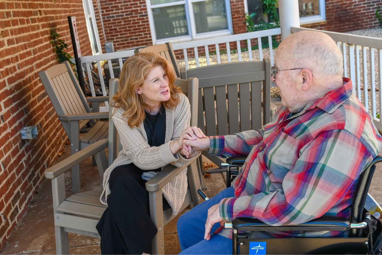 daughter and father talking on patio