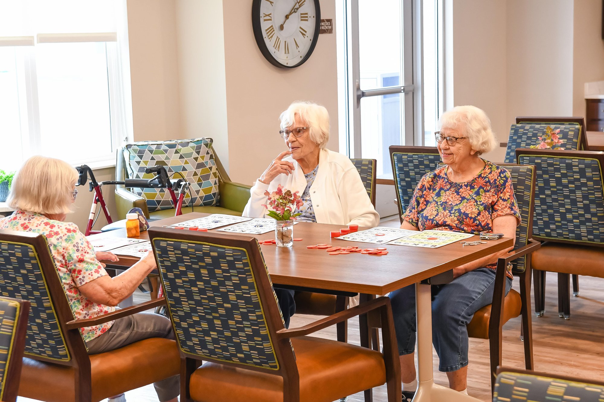 women sitting around table playing game