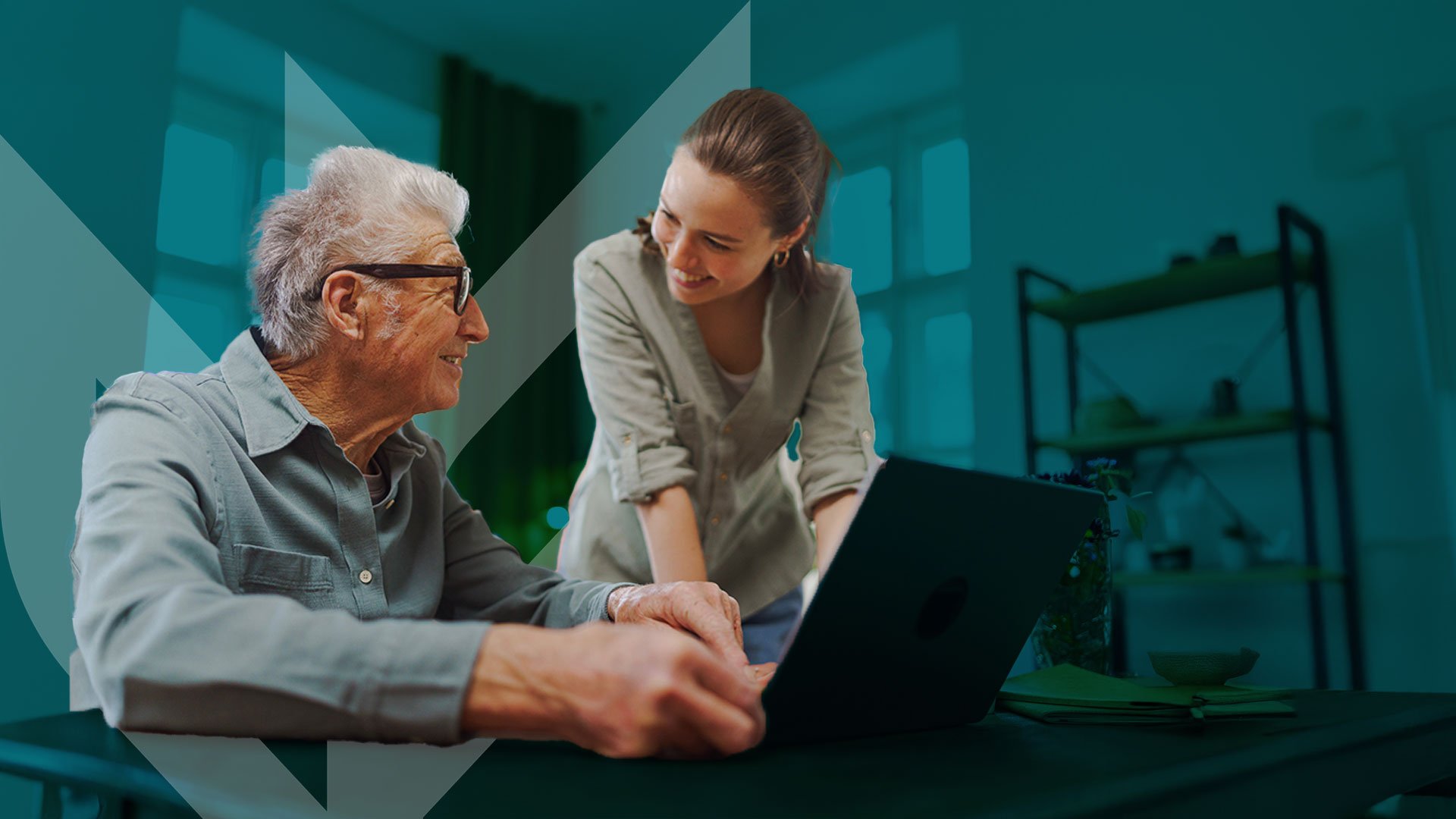 older man on laptop smiling at younger woman