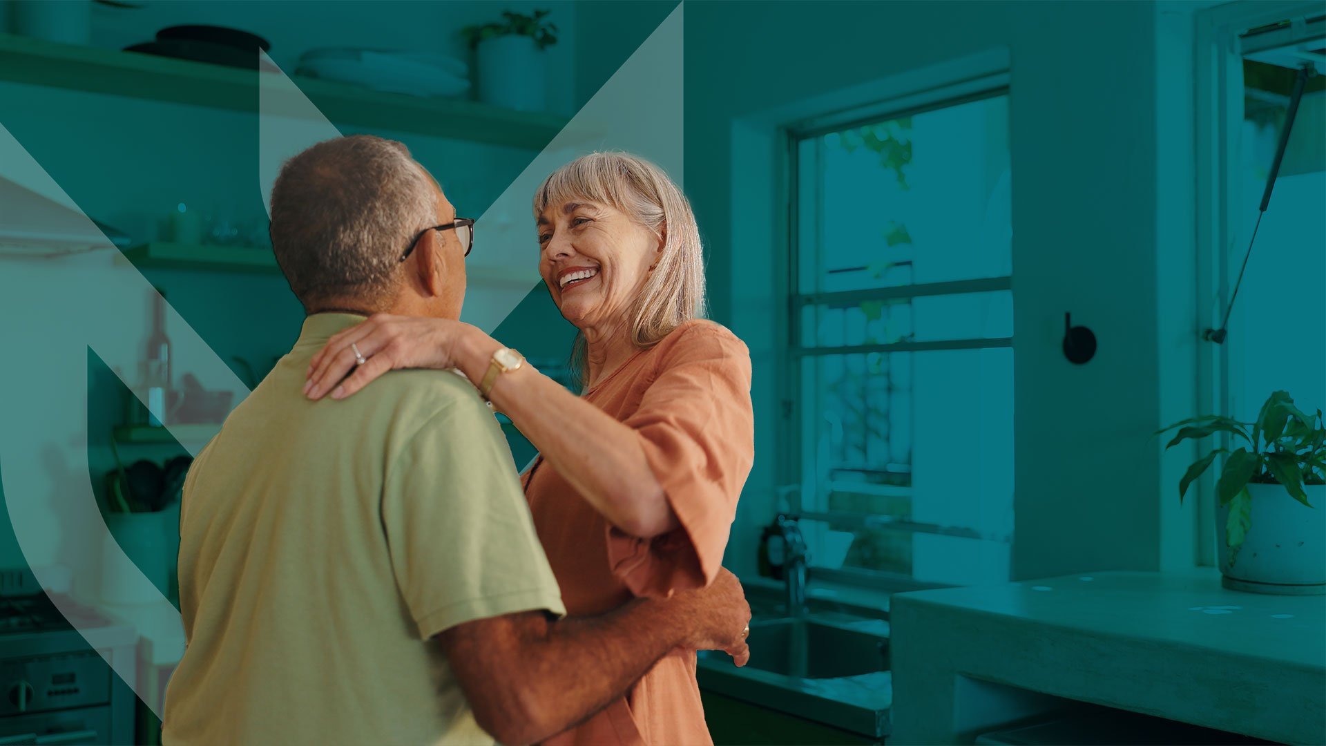 Photo of an older man and woman dancing in senior living apartment