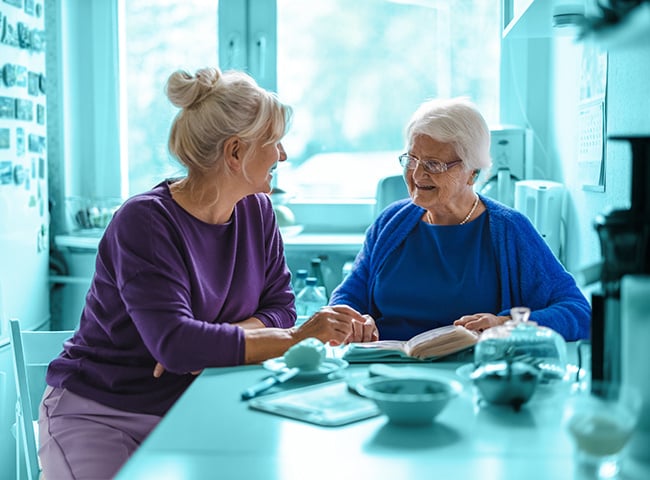 Photo of a female caregiver assisting an elderly resident