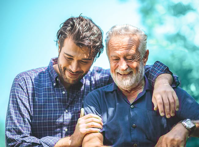Photo of a respite caregiver supporting an elderly man