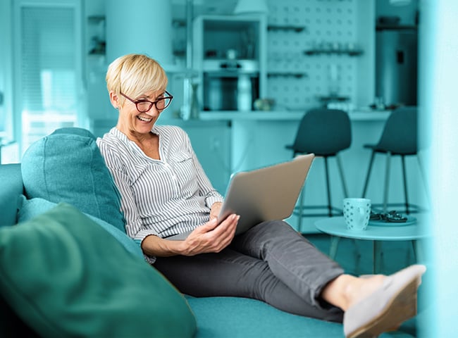 Photo of a woman using a tablet in memory care living