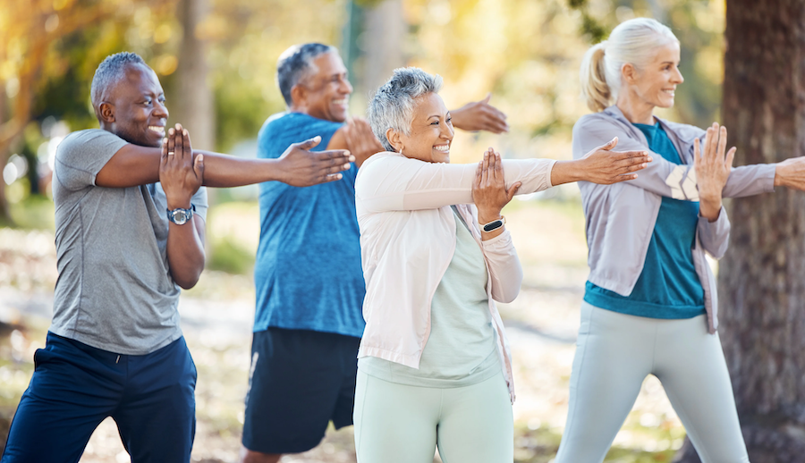 group of older adults stretching outdoors