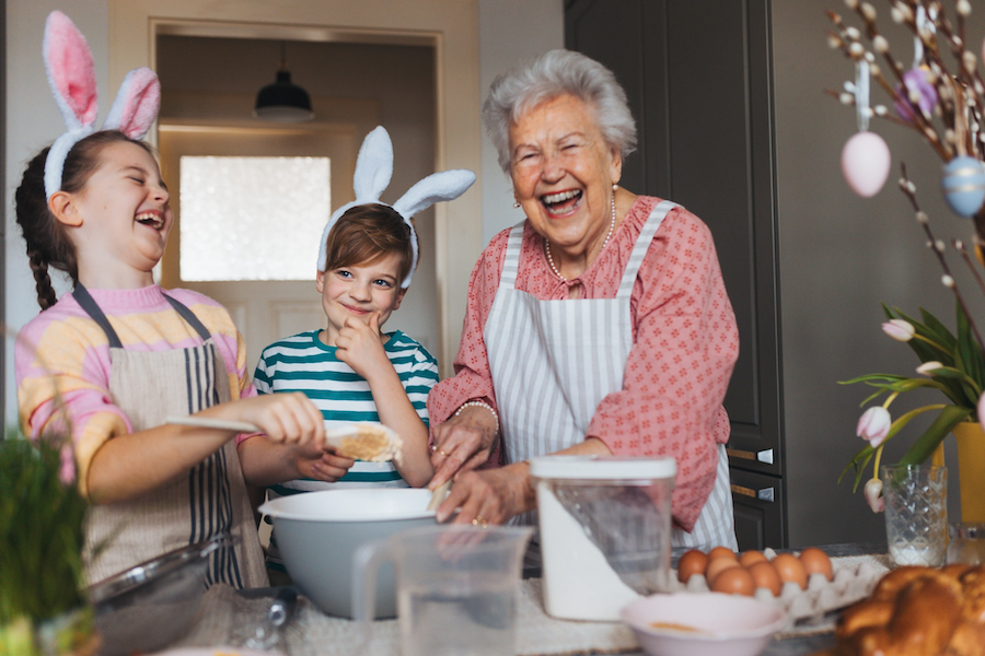 Photo of children in kitchen cooking with grandmother