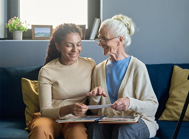 Photo of two women looking at a scrapbook