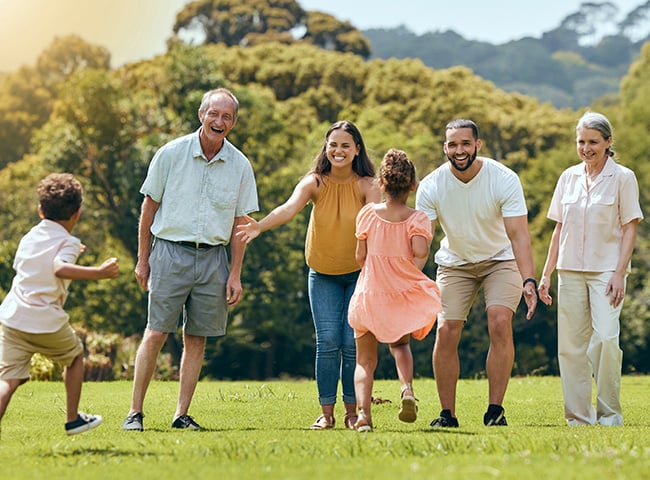 Photo of a family running and playing in a field
