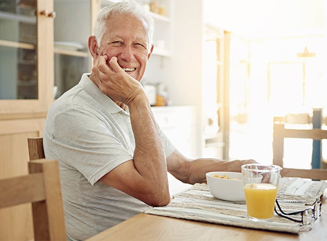 Photo of an older man eating breakfast