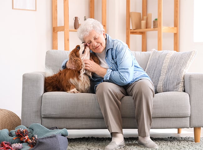 Photo of a woman with a therapy dog in short term care