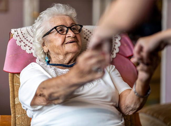 Photo of a woman recovering from surgery in short term care