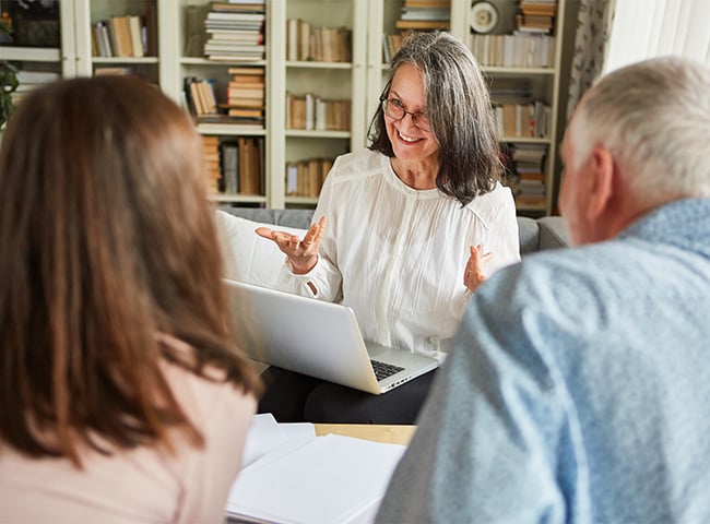 Photo of a long-term care provider talking with residents