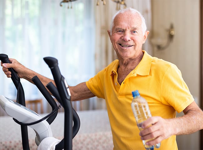 Photo of a man on exercise equipment for physical rehab