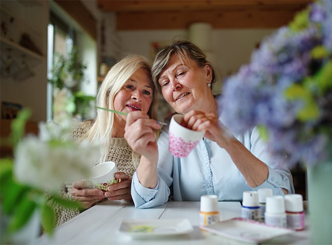 Photo of women painting cups