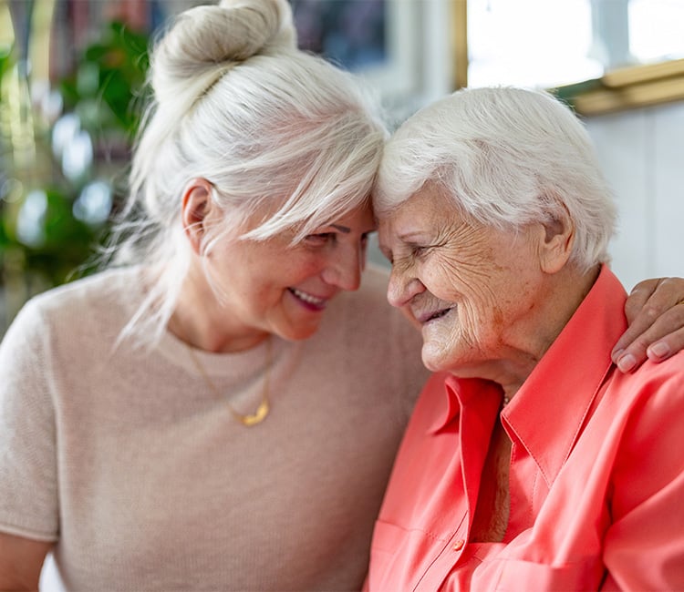 Two women smiling and hugging