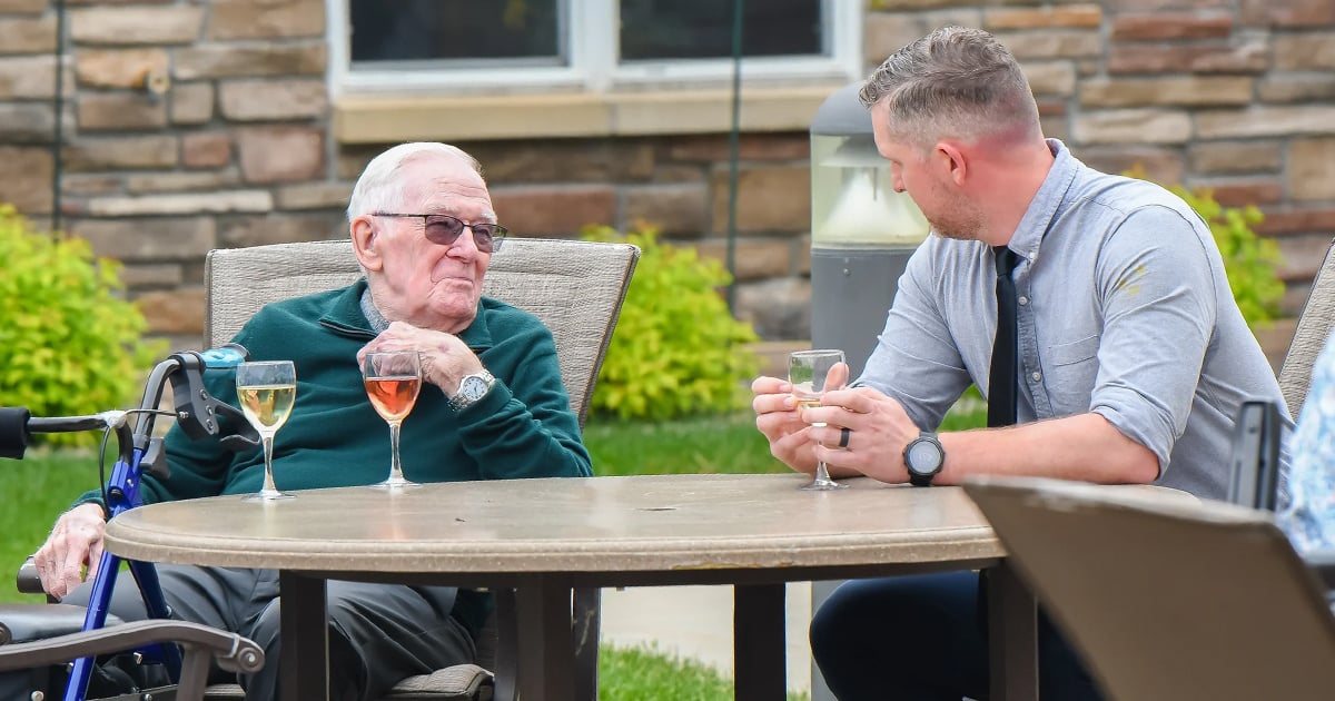 men with beverages on patio