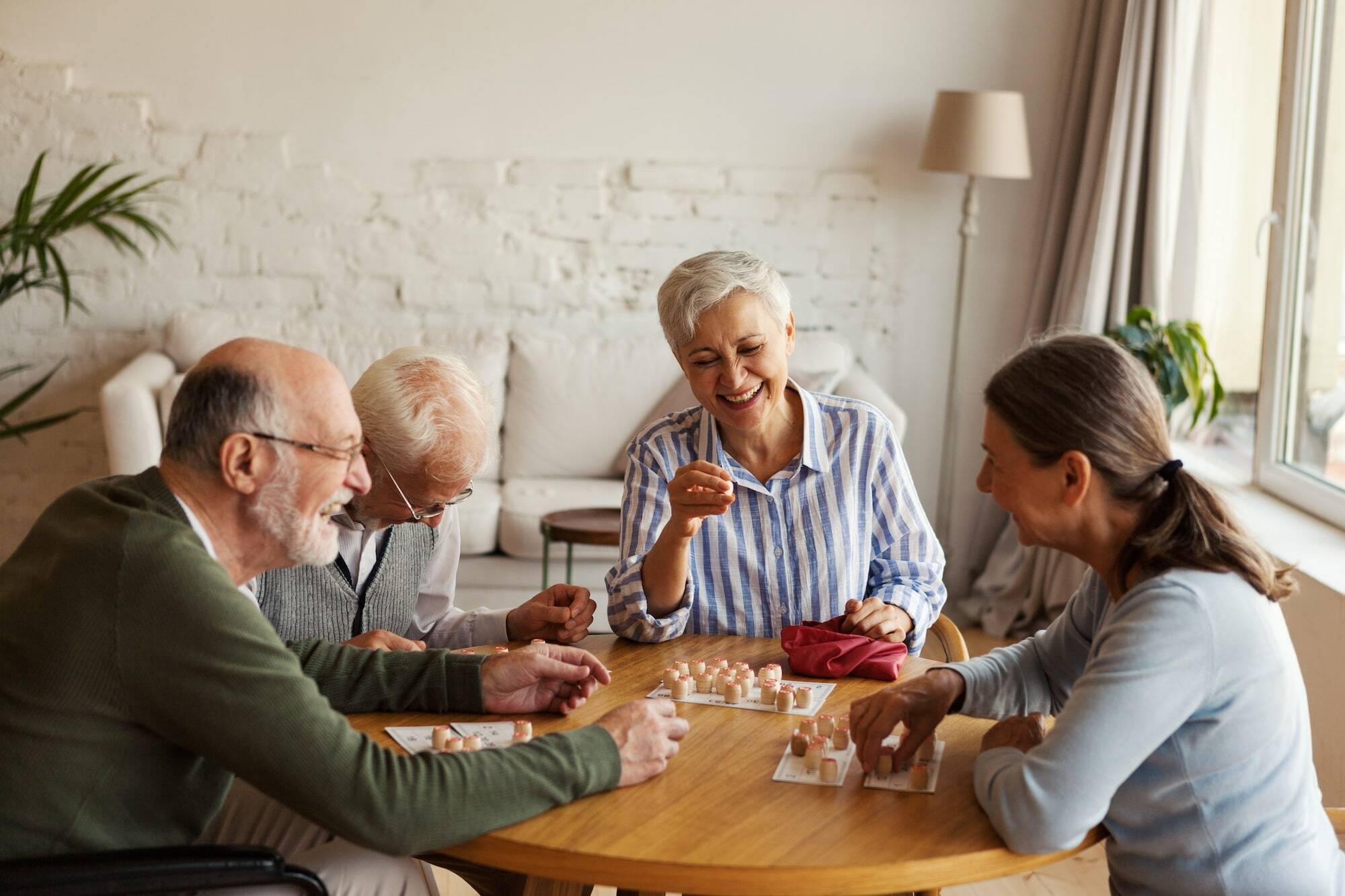 four people at table laughing